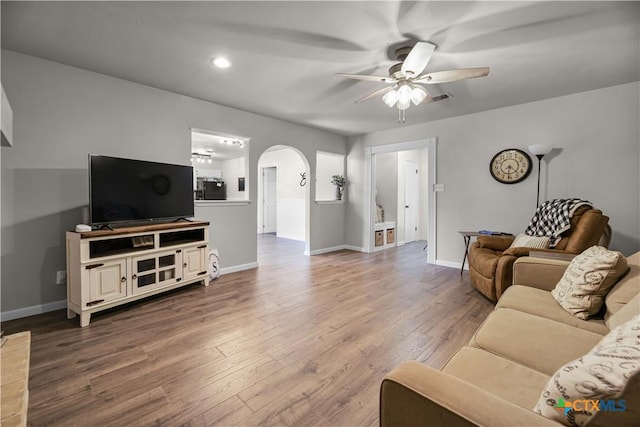 living room featuring ceiling fan and hardwood / wood-style flooring