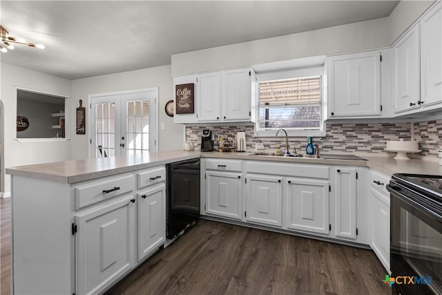 kitchen with black appliances, white cabinets, kitchen peninsula, and sink