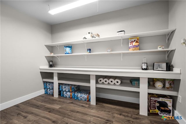 clothes washing area featuring dark wood-type flooring