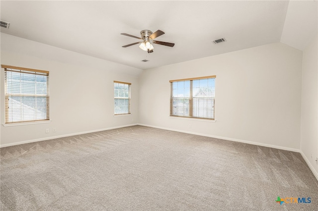 spare room featuring carpet flooring, plenty of natural light, ceiling fan, and lofted ceiling