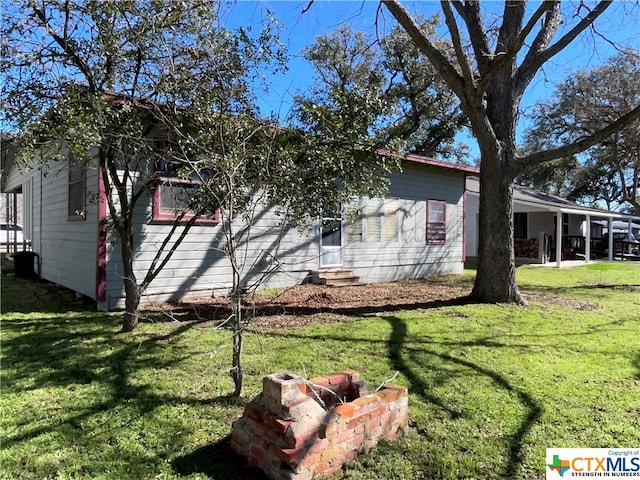 view of side of property with a yard