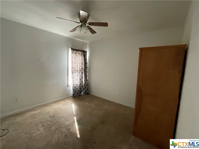 spare room featuring carpet flooring and ceiling fan