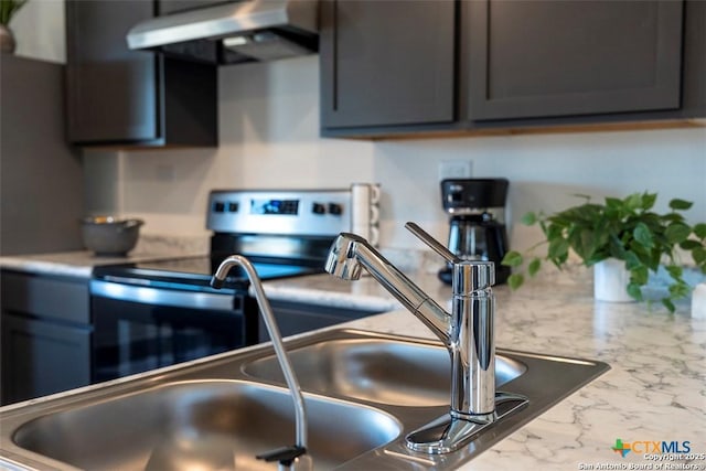 kitchen featuring extractor fan, stainless steel electric range, light stone countertops, and sink