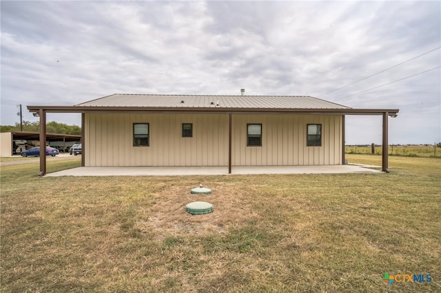 back of property with a patio and a lawn