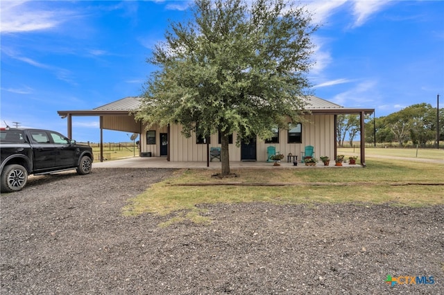 view of front of property with a carport and a front lawn