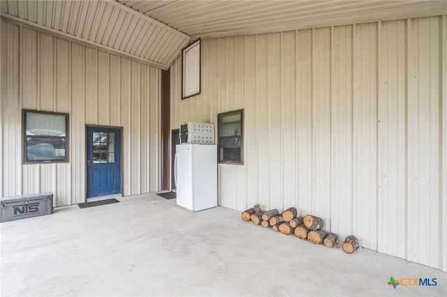 view of exterior entry with a patio area