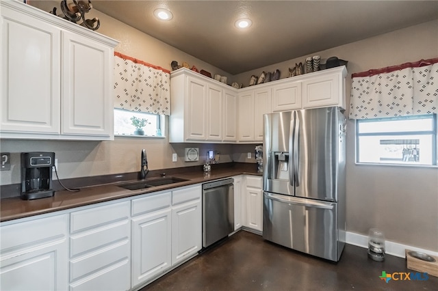 kitchen with white cabinets, appliances with stainless steel finishes, and a healthy amount of sunlight