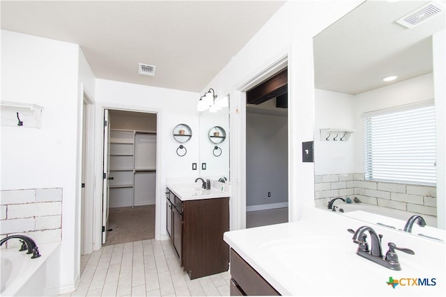3814 Twilight Dr, Temple, TX 76502 - bathroom with vanity, a bath, a spacious closet, and tile patterned flooring