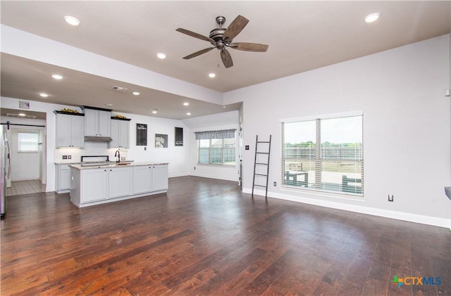 3814 Twilight Dr, Temple, TX 76502 - living room featuring dark wood finished floors, a ceiling fan, a barn door, and recessed lighting