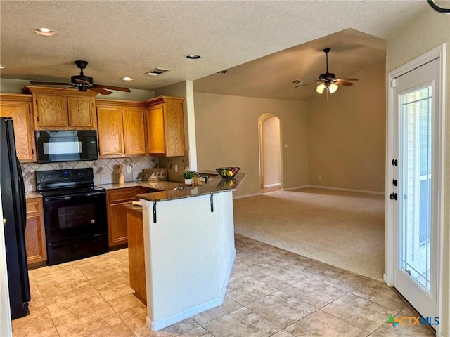 3508 Lucas St, Copperas Cove, TX 76522 - kitchen featuring black appliances, ceiling fan, a peninsula, healthy amount of natural light, and a textured ceiling
