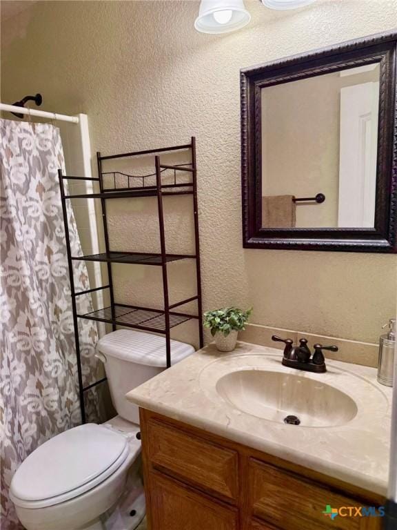 3508 Lucas St, Copperas Cove, TX 76522 - bathroom featuring a textured wall, toilet, vanity, and a shower with curtain