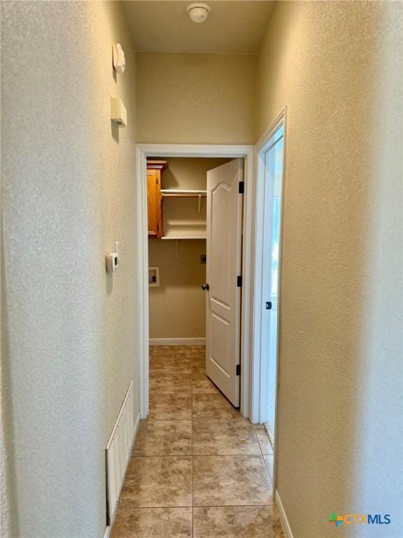 3508 Lucas St, Copperas Cove, TX 76522 - hallway with light tile patterned floors and a textured wall