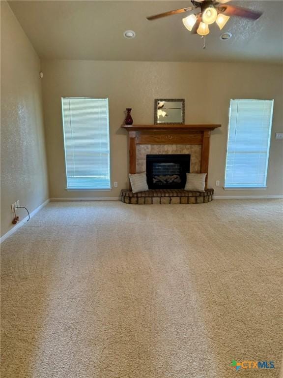 3508 Lucas St, Copperas Cove, TX 76522 - carpeted living room with a ceiling fan, a fireplace with raised hearth, baseboards, and healthy amount of natural light