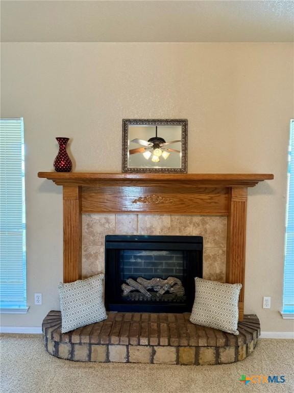 3508 Lucas St, Copperas Cove, TX 76522 - detailed view of carpet, a tiled fireplace, and baseboards