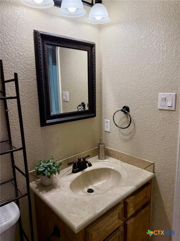 3508 Lucas St, Copperas Cove, TX 76522 - bathroom with vanity and a textured wall
