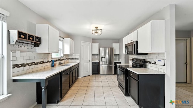 912 Bexley Dr, Seguin, TX 78155 - kitchen featuring black appliances, decorative backsplash, and white cabinets