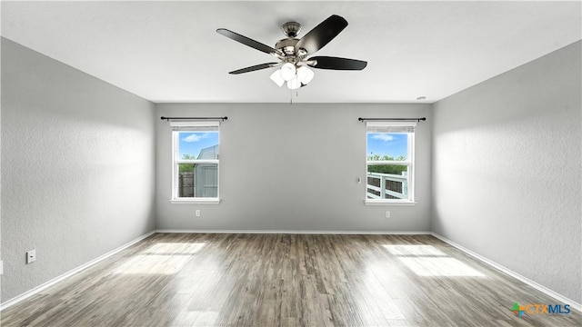 912 Bexley Dr, Seguin, TX 78155 - spare room with plenty of natural light, a textured wall, wood finished floors, and ceiling fan