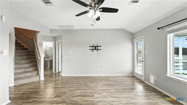 912 Bexley Dr, Seguin, TX 78155 - unfurnished living room with plenty of natural light, wood finished floors, ceiling fan, and vaulted ceiling