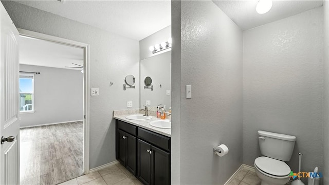 912 Bexley Dr, Seguin, TX 78155 - bathroom with double vanity, a textured wall, and tile patterned floors