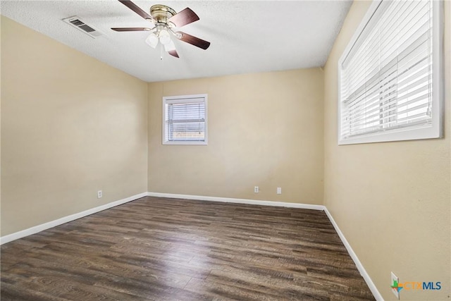 empty room featuring ceiling fan and dark wood-type flooring