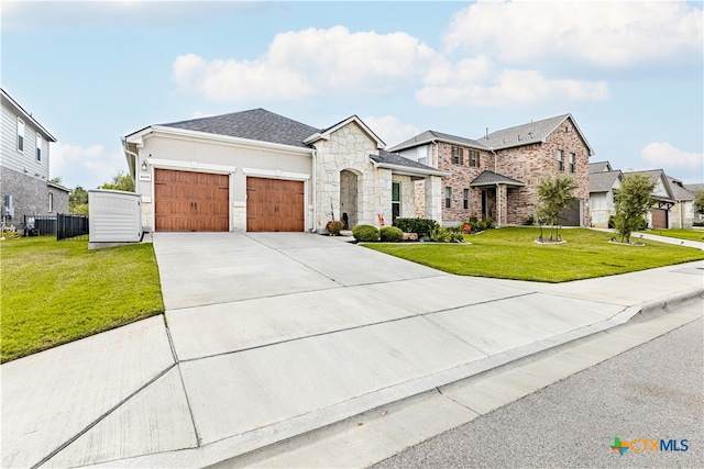 view of front of property featuring a front lawn and a garage