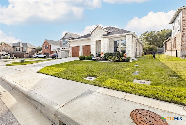 view of front of property featuring a front lawn and a garage