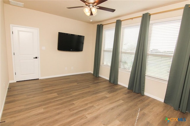 spare room with ceiling fan and wood-type flooring