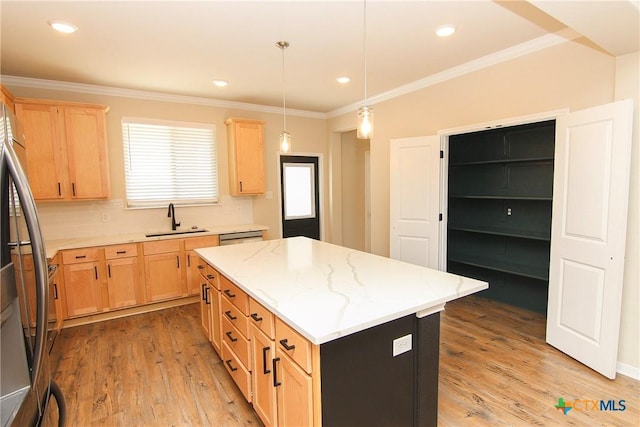 kitchen with sink, light hardwood / wood-style flooring, backsplash, decorative light fixtures, and a kitchen island