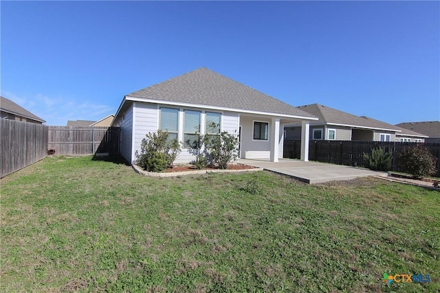 back of property featuring a patio area and a yard