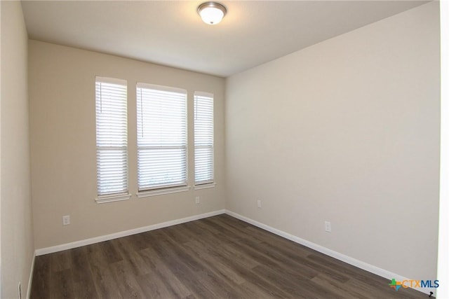 empty room featuring dark wood-type flooring