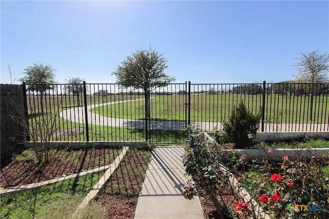 view of gate with a yard