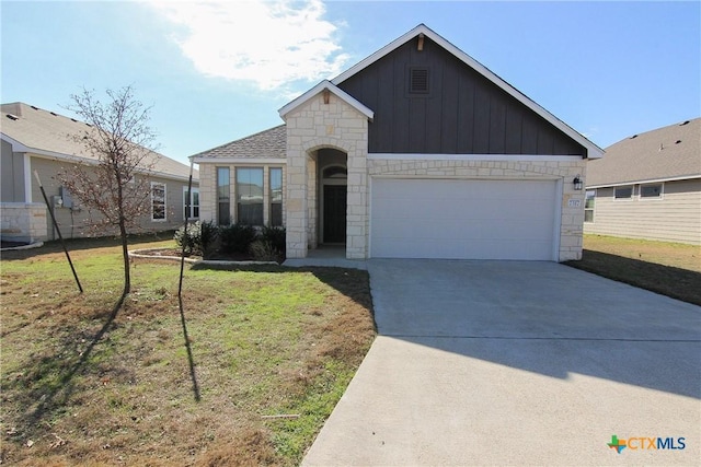 view of front of property with a front yard and a garage