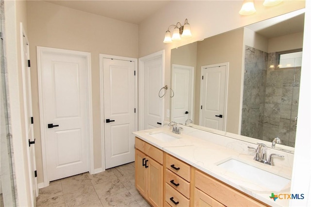 bathroom with tile patterned flooring, vanity, and walk in shower