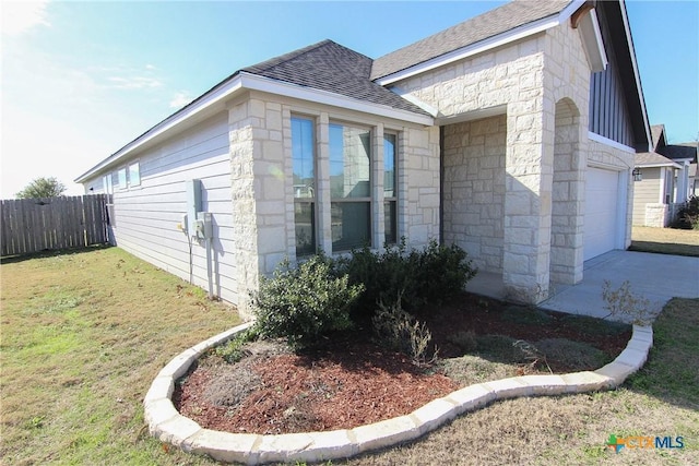 view of side of property with a yard