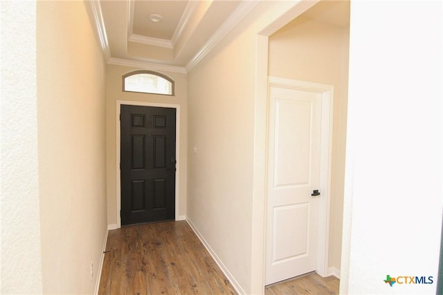 entryway with ornamental molding and light hardwood / wood-style flooring