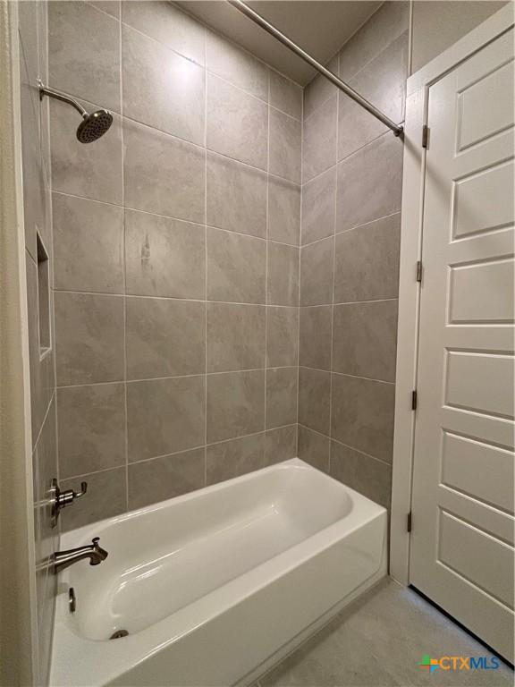 bathroom with tile patterned floors and shower / bathtub combination