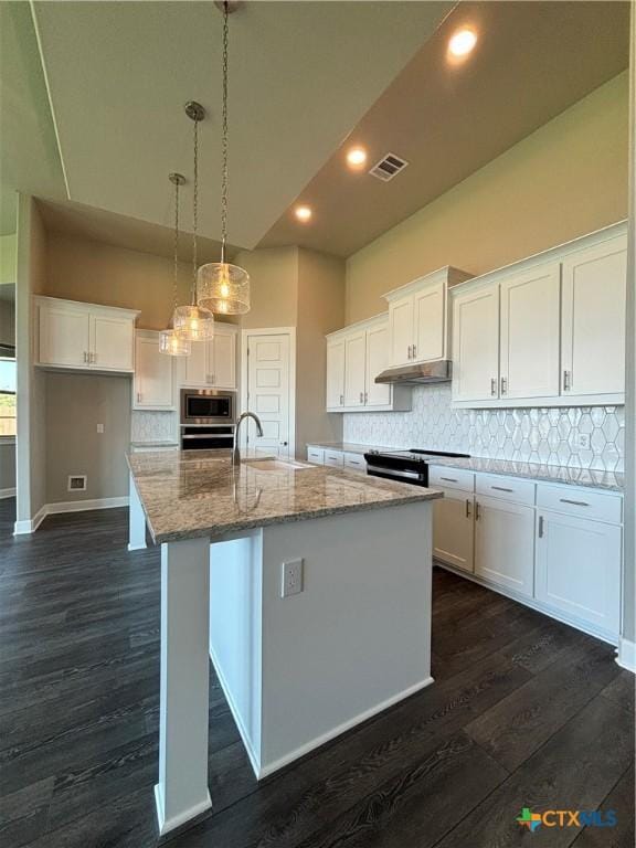 kitchen featuring appliances with stainless steel finishes, white cabinetry, visible vents, and under cabinet range hood