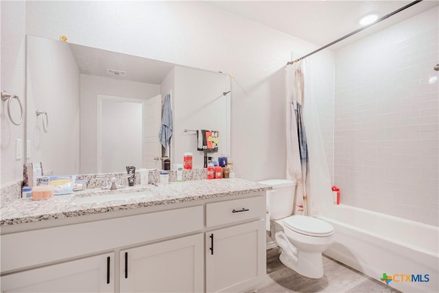 full bathroom with toilet, vanity, and shower / bath combo