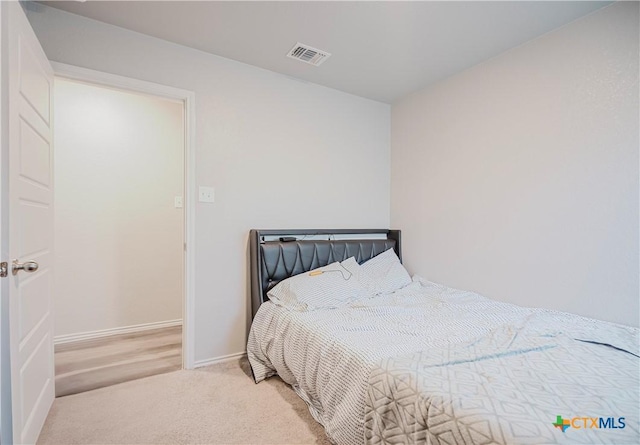 bedroom featuring light carpet