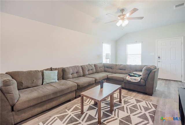 living room with lofted ceiling, light wood-type flooring, and ceiling fan