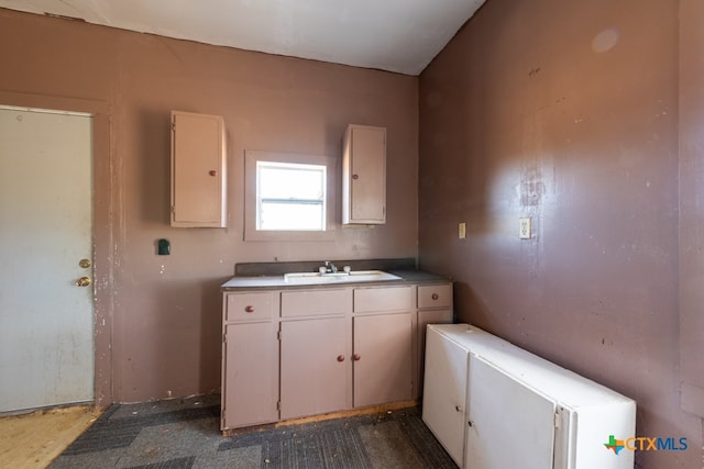 kitchen with white cabinetry and sink