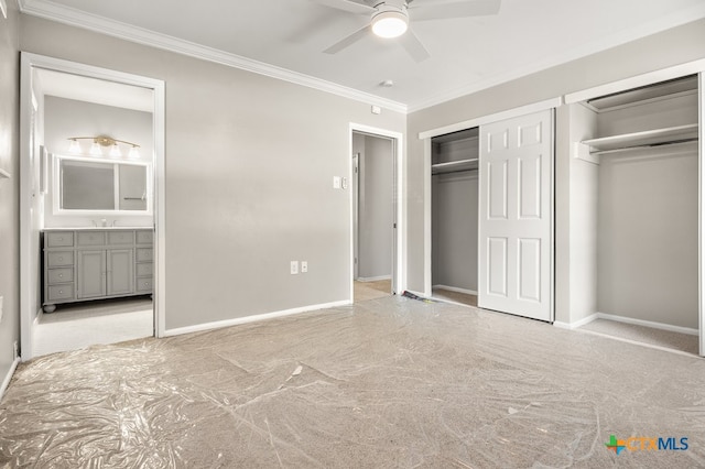 unfurnished bedroom with ceiling fan, light carpet, and two closets