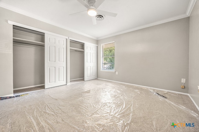 unfurnished bedroom featuring ornamental molding, light colored carpet, and ceiling fan