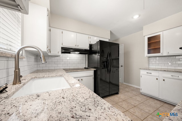 kitchen with backsplash, white cabinetry, sink, and black appliances