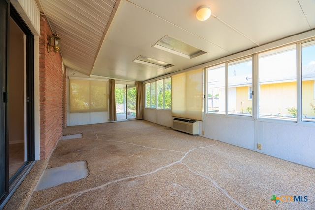 unfurnished sunroom featuring a wealth of natural light and vaulted ceiling