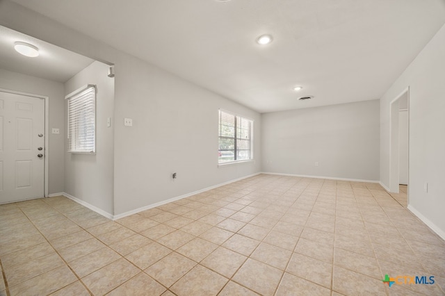 spare room with light tile patterned flooring