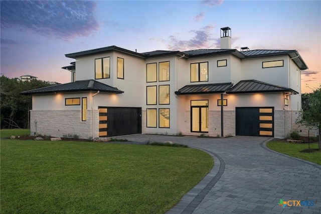 view of front of home featuring a lawn and a garage