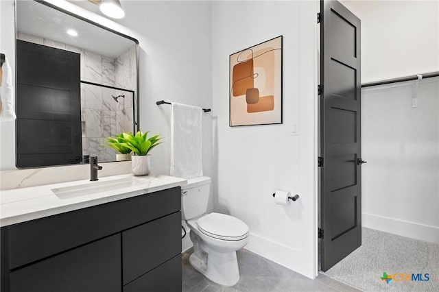 bathroom featuring vanity, toilet, and a shower with door