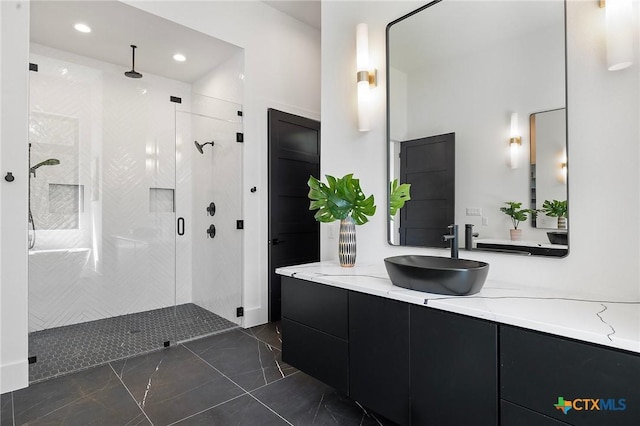 bathroom featuring vanity and a shower with door