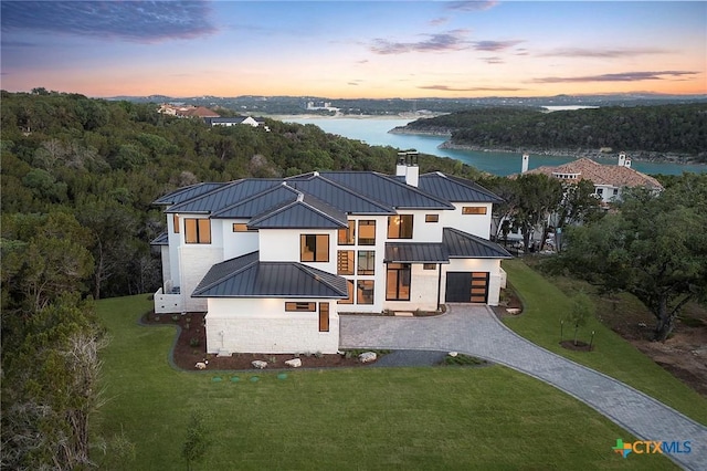 aerial view at dusk with a water view